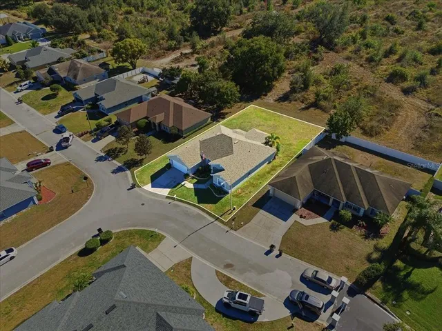 an aerial view of a house with a yard