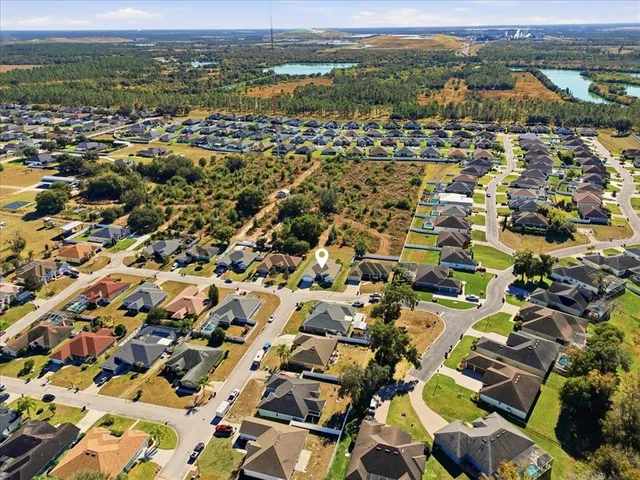 an aerial view of residential houses with outdoor space