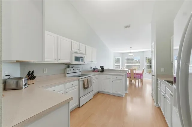 a kitchen with a sink cabinets and window