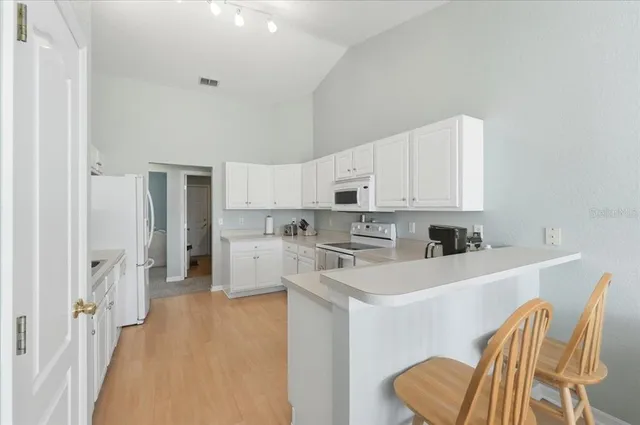 a kitchen with stainless steel appliances cabinets a sink and a refrigerator