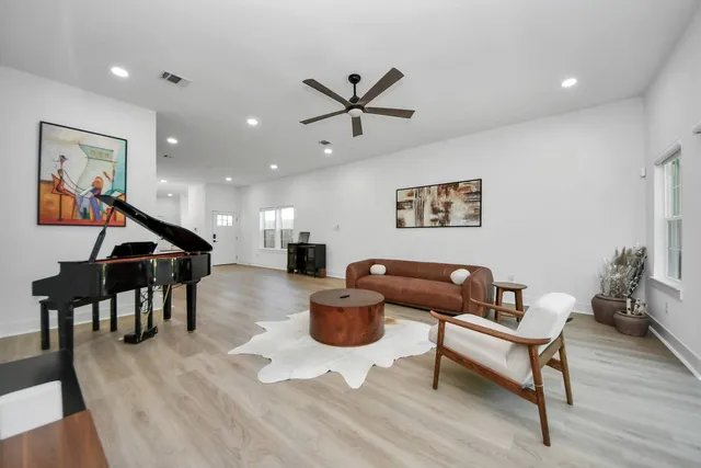a living room with furniture and a wooden floor