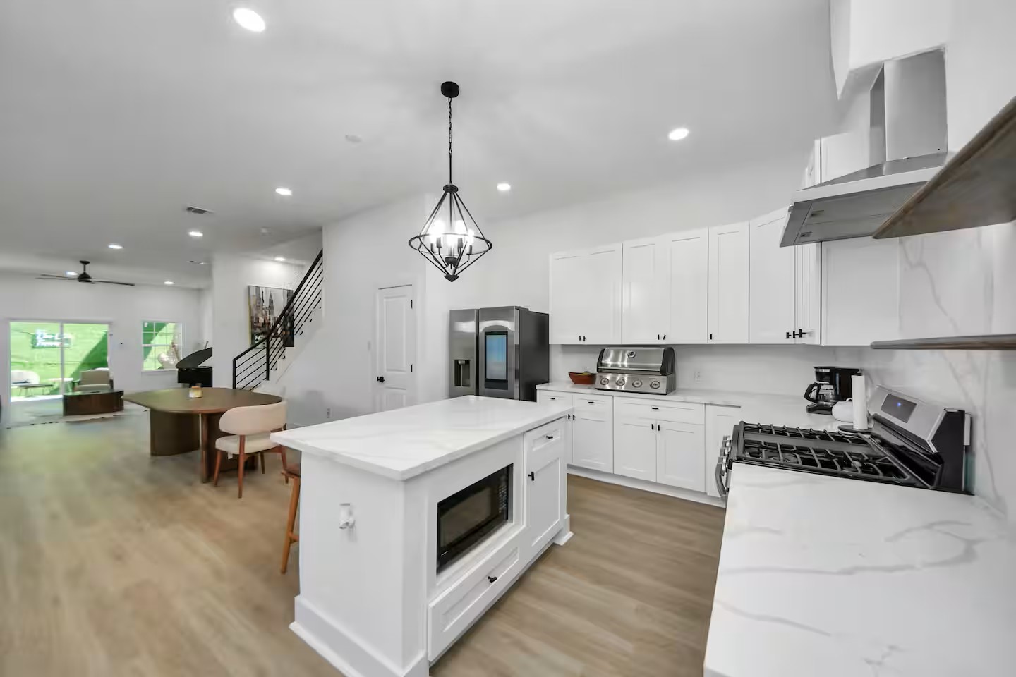 6747 Peerless Street Houston, TX 77021 - Photo 22 of 33 a kitchen that has a lot of stainless steel appliances and wooden floor