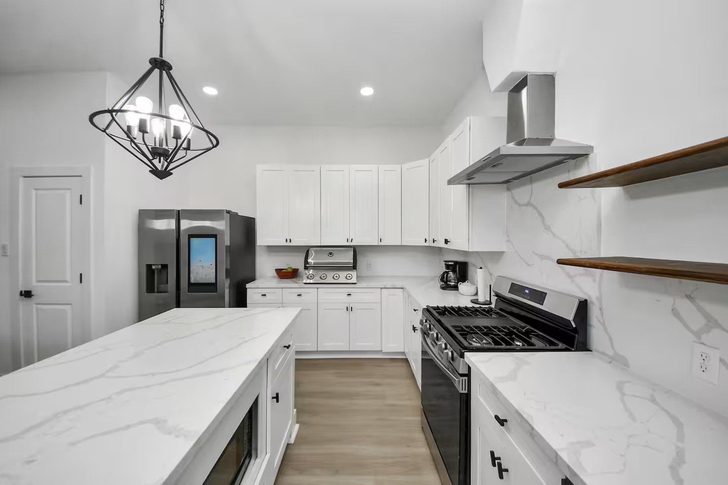 6747 Peerless Street Houston, TX 77021 - Photo 8 of 33 a kitchen with a stove and a chandelier