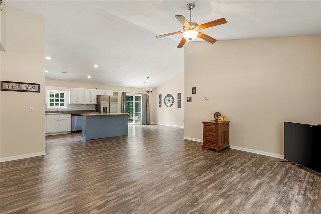 167 Mediterranean Avenue Anderson, SC 29621 - Photo 7 of 33 An airy living space with vaulted ceilings flows into a kitchen featuring modern appliances.