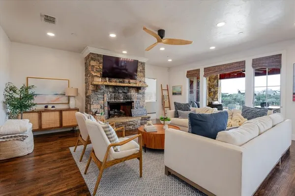 a living room with furniture fireplace and a large window