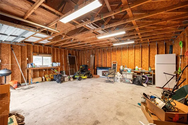 an empty room with wooden floor and door