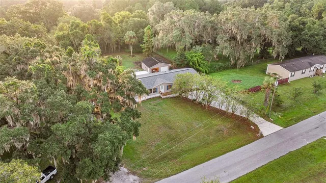 an aerial view of residential houses with outdoor space