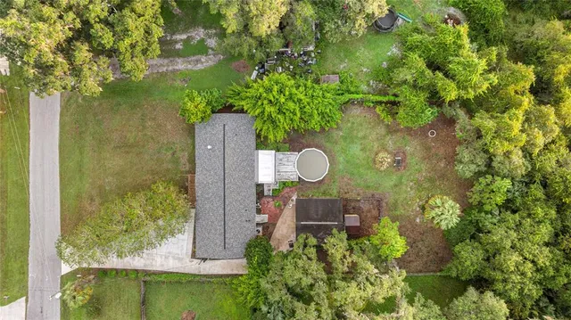 a front view of house with yard and trees around