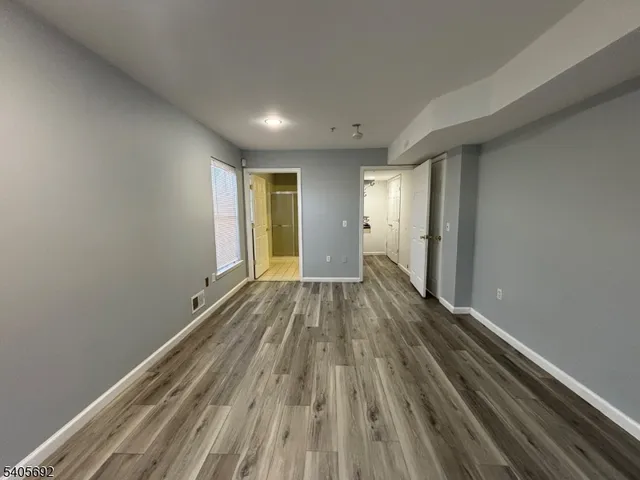 a view of a room with wooden floor and window