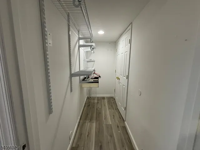 a view of hallway with wooden floor