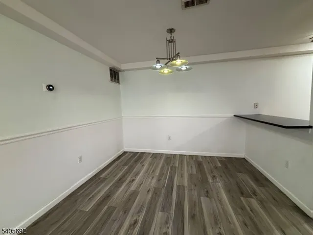 a view of a room with wooden floor fan and window