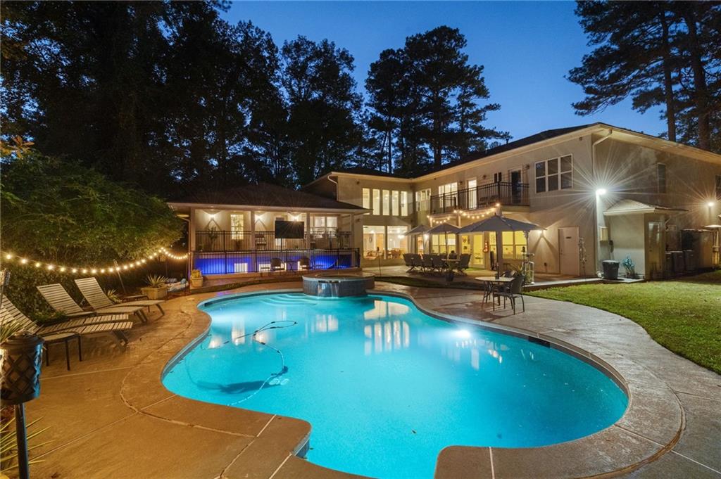 a view of a swimming pool with seating space