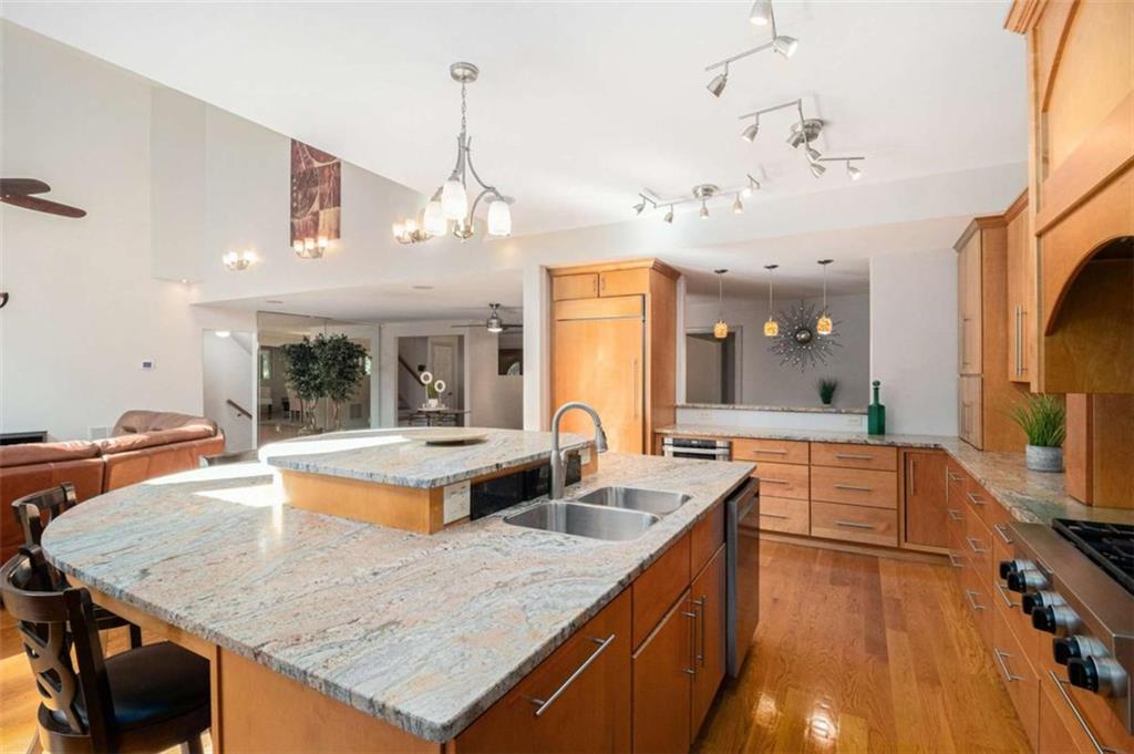 2994 East Ramble Lane Decatur, GA 30033 - Photo 15 of 111 a kitchen with stainless steel appliances granite countertop a sink a stove and a wooden floor