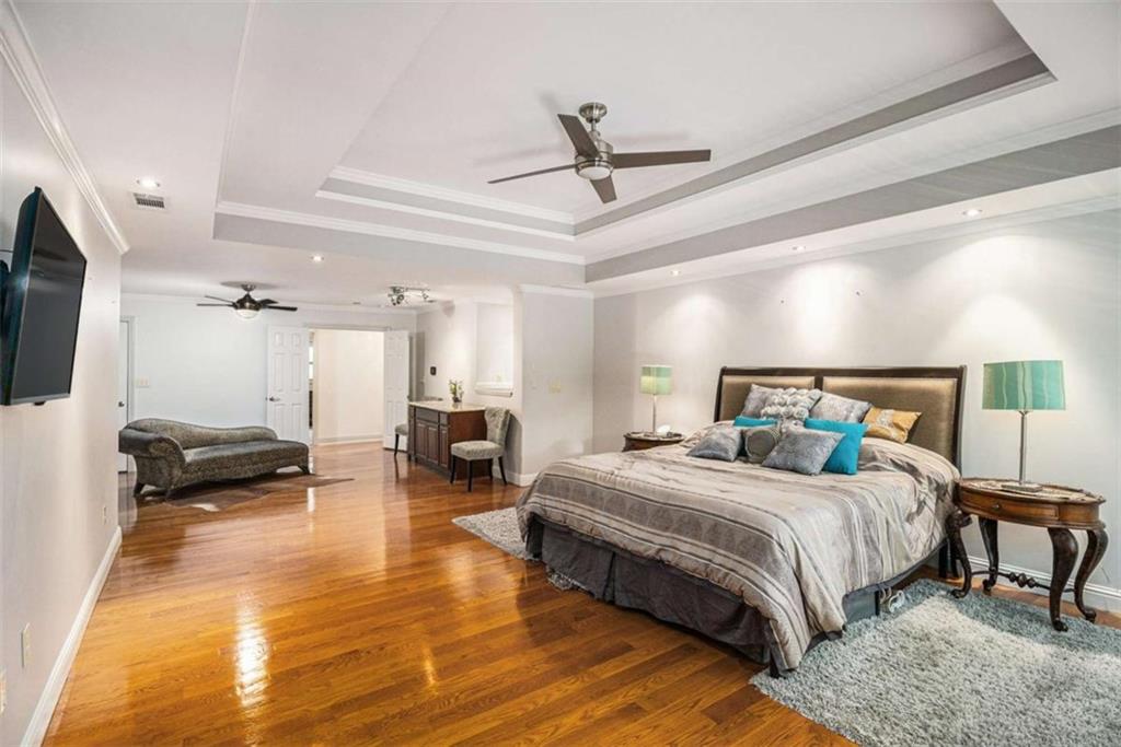 2994 East Ramble Lane Decatur, GA 30033 - Photo 25 of 111 a bedroom with a bed a couch and a flat screen tv