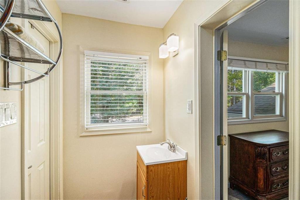 2994 East Ramble Lane Decatur, GA 30033 - Photo 40 of 111 a bathroom with a sink a mirror and a window