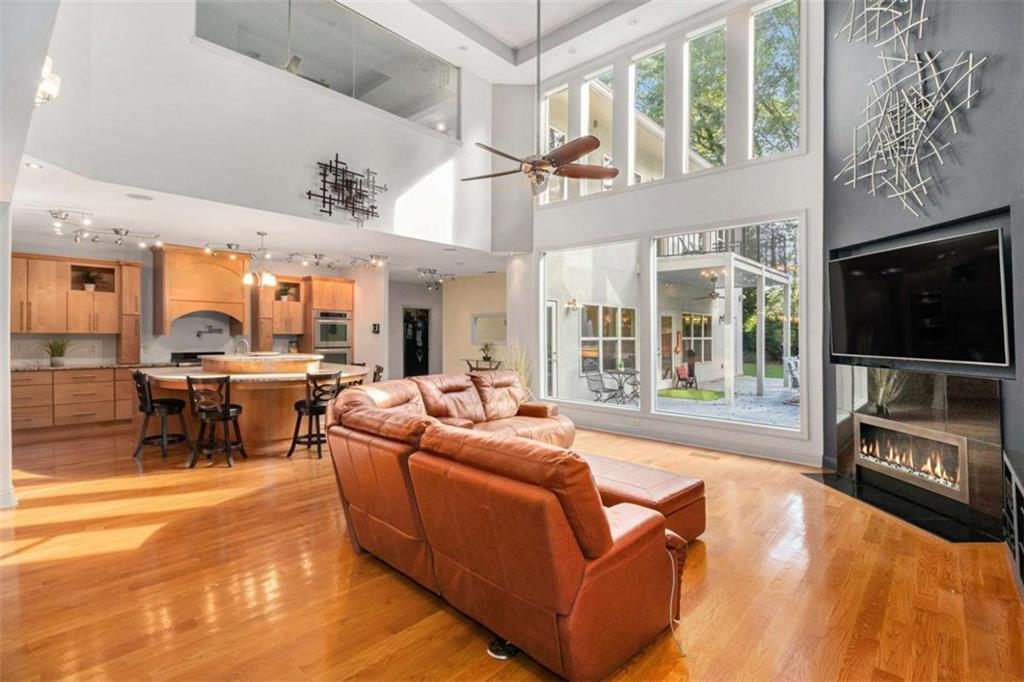 2994 East Ramble Lane Decatur, GA 30033 - Photo 5 of 111 a living room with furniture a flat screen tv and a fireplace