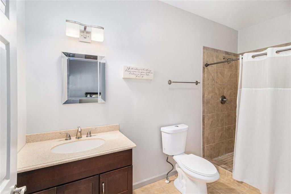 2994 East Ramble Lane Decatur, GA 30033 - Photo 75 of 111 a bathroom with a sink toilet vanity and shower