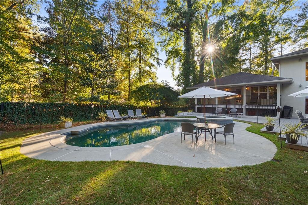 2994 East Ramble Lane Decatur, GA 30033 - Photo 88 of 111 a view of a swimming pool with table and chairs under an umbrella