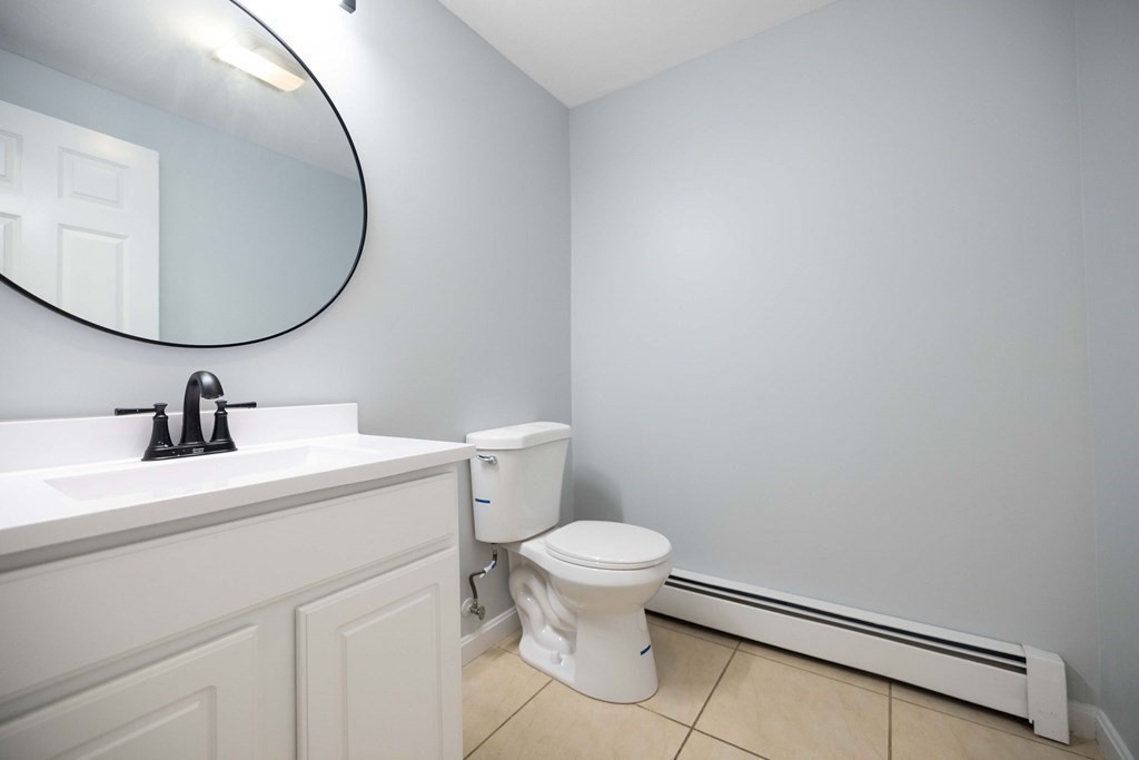 32 Rodney Street Worcester, MA 01605 - Photo 20 of 37 a bathroom with a sink a toilet and a mirror