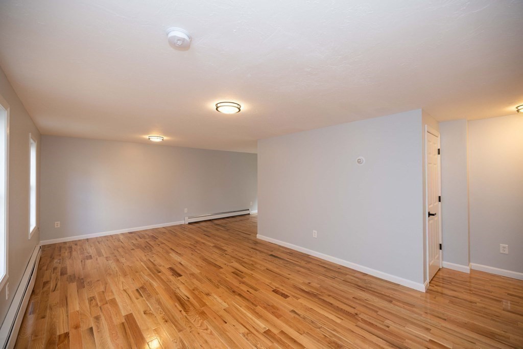 32 Rodney Street Worcester, MA 01605 - Photo 2 of 37 a view of an empty room with wooden floor