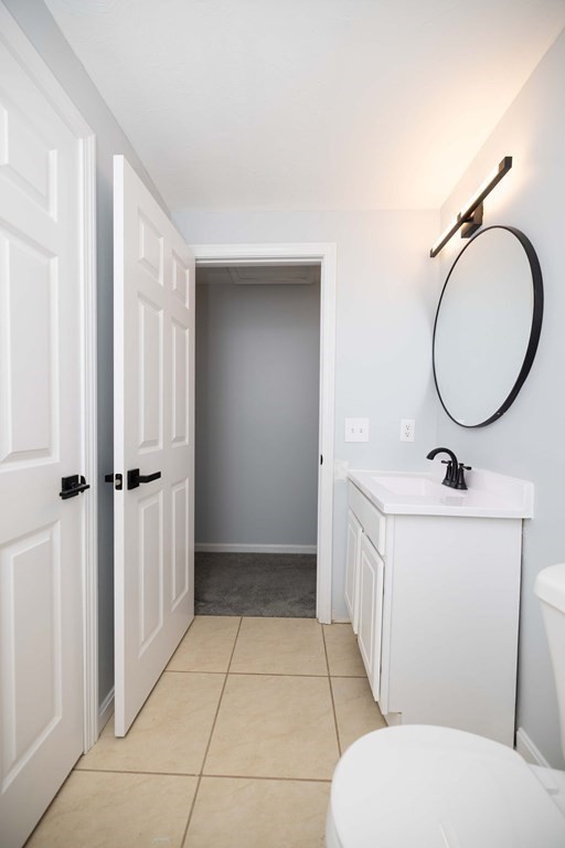 32 Rodney Street Worcester, MA 01605 - Photo 21 of 37 a bathroom with a toilet a sink and mirror