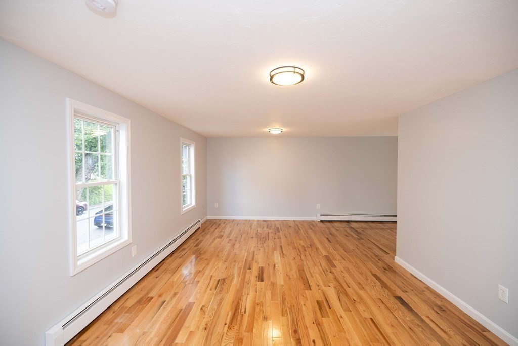32 Rodney Street Worcester, MA 01605 - Photo 4 of 37 an empty room with wooden floor and windows