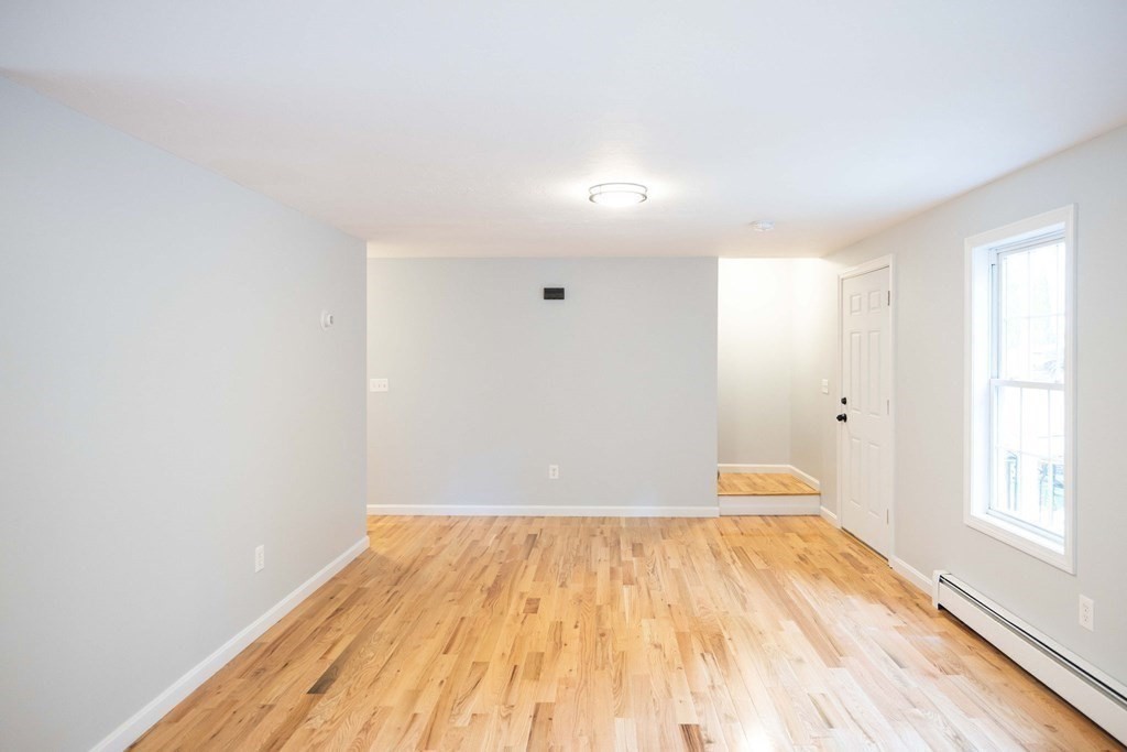 32 Rodney Street Worcester, MA 01605 - Photo 5 of 37 a view of empty room with wooden floor and fan