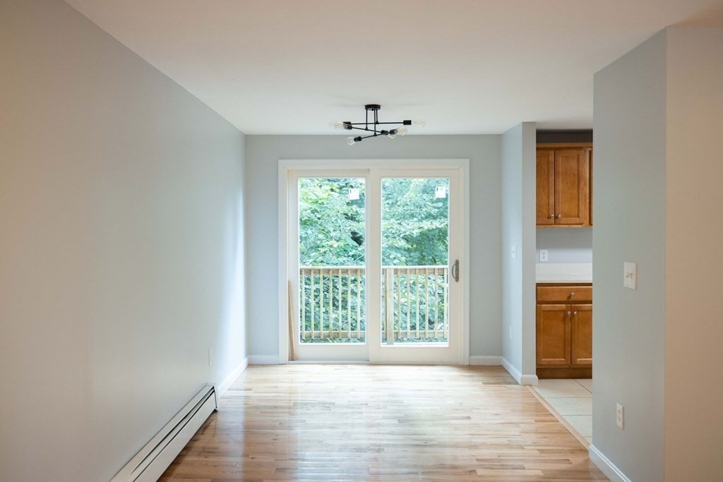 32 Rodney Street Worcester, MA 01605 - Photo 6 of 37 an empty room with wooden floor and windows