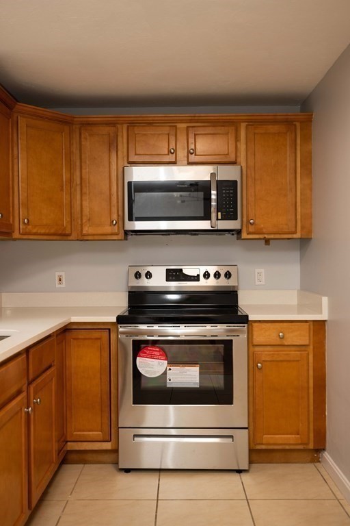 32 Rodney Street Worcester, MA 01605 - Photo 10 of 37 a kitchen with a stove and a microwave