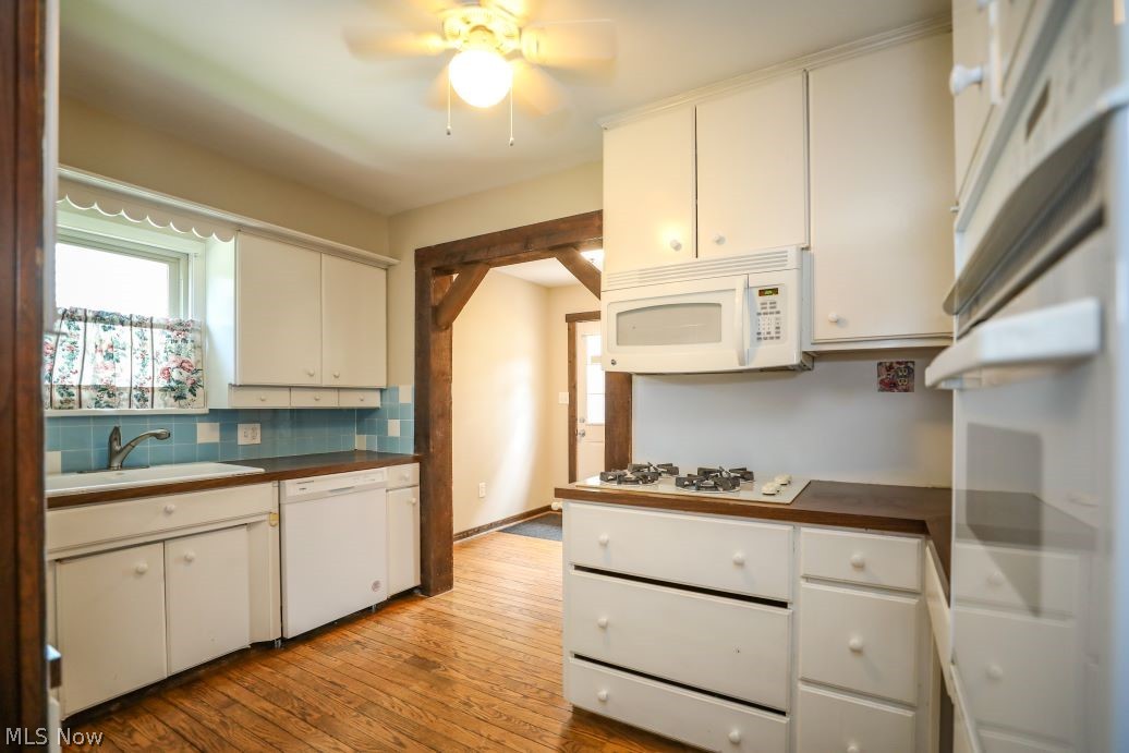 728 East Riddle Avenue Ravenna, OH 44266 - Photo 17 of 40 Kitchen with white cabinetry, white appliances, light wood-type flooring, ceiling fan, and sink