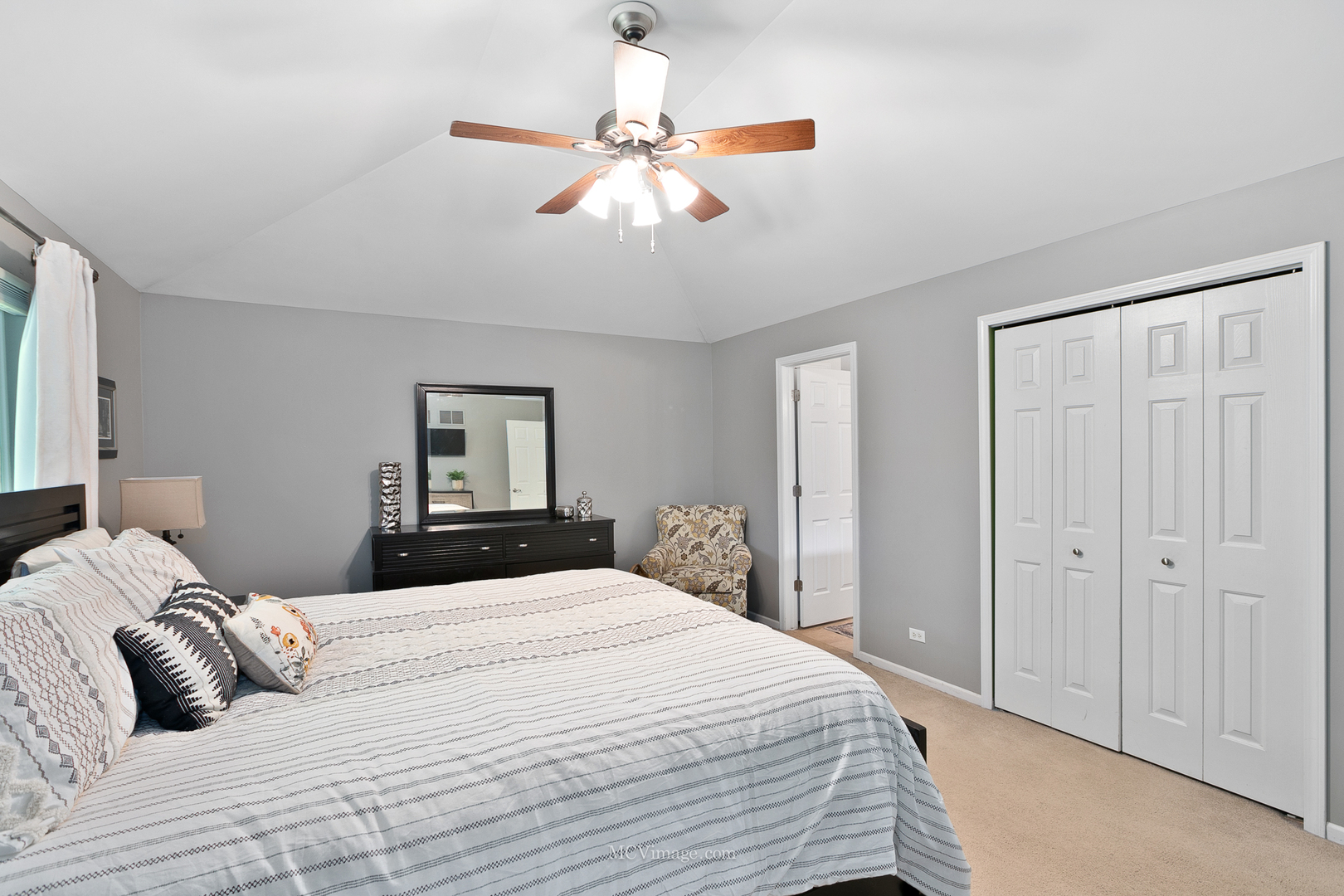 40 Zurich Court Crete, IL 60417 - Photo 22 of 40 a bedroom with a large bed and a chandelier