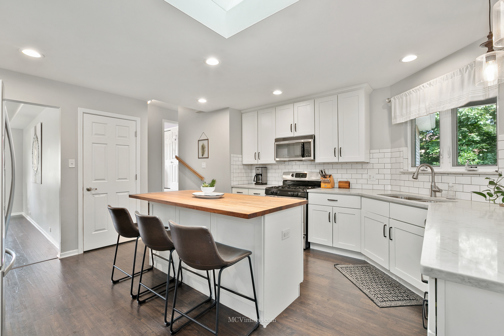 40 Zurich Court Crete, IL 60417 - Photo 10 of 40 a kitchen with stainless steel appliances granite countertop a table chairs sink refrigerator and cabinets