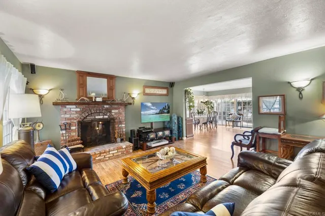 a living room with furniture a rug and a table