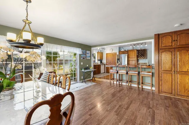 a living room with furniture dining table and wooden floor
