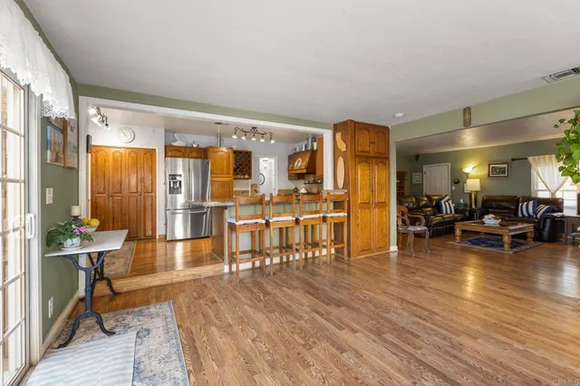 a kitchen with stainless steel appliances granite countertop a refrigerator a stove oven and sink