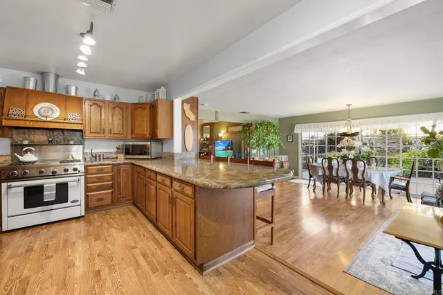 a large kitchen with kitchen island a sink stainless steel appliances and cabinets
