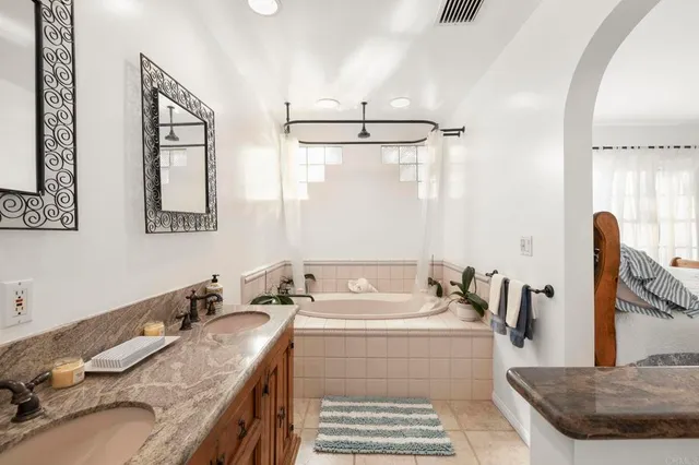 a bedroom with a bed and large windows