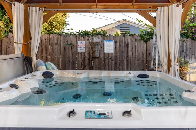 a view of a patio with a table and chairs under an umbrella