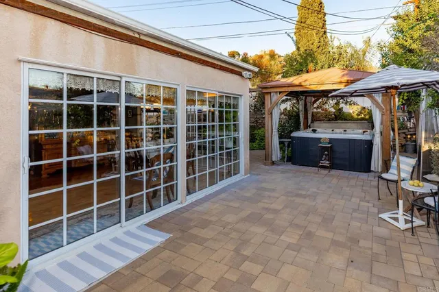 a view of a house with a yard and potted plants