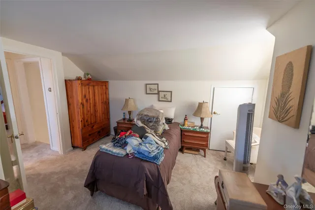 a bed room with a bed and a chair