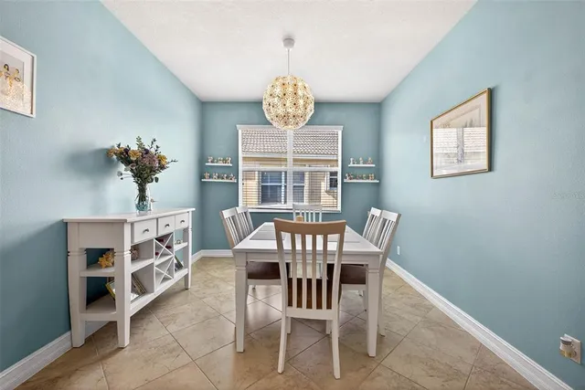 a view of a dining room with furniture and a potted plant