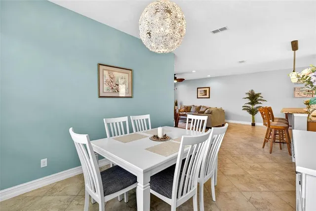 a dining room with stainless steel appliances kitchen island granite countertop furniture and a view of kitchen
