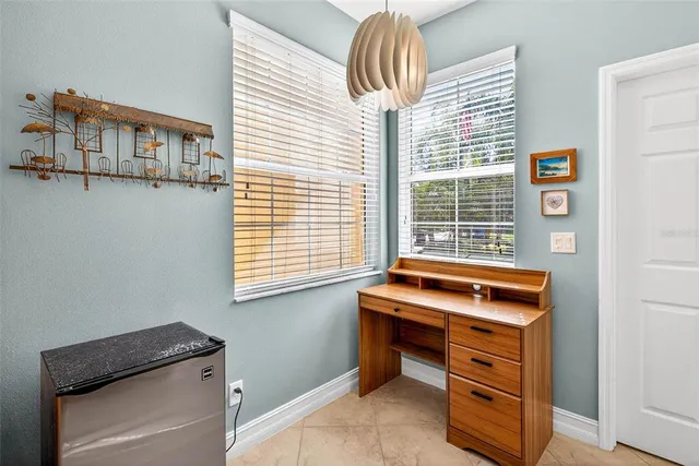 a bedroom with a bed and painting on the wall