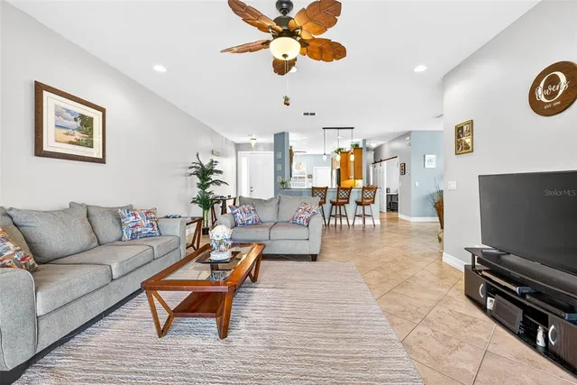 a view of a dining room with furniture a chandelier and wooden floor