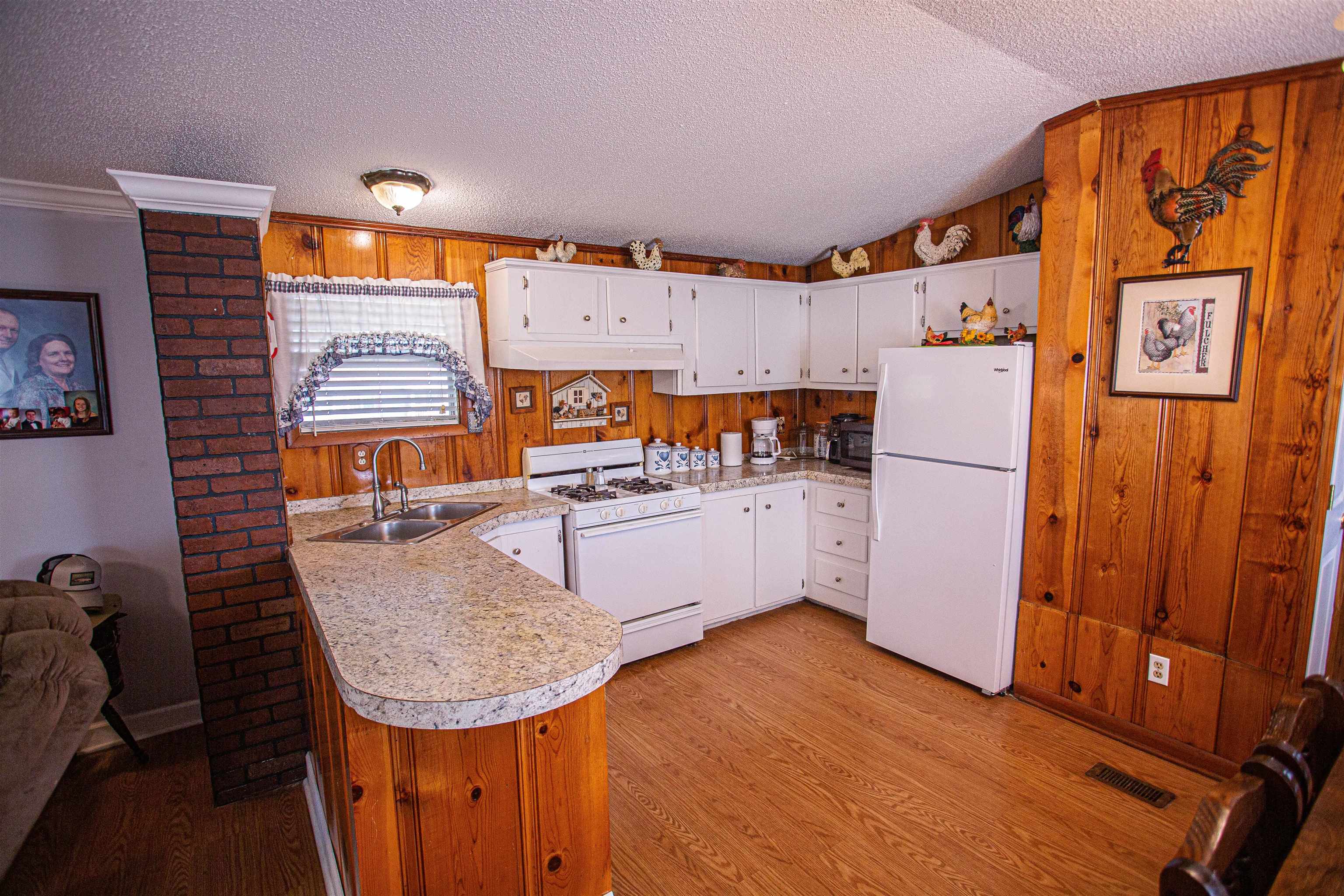 4100 Highway 209 Ripley, TN 38063 - Photo 11 of 36 a kitchen with stainless steel appliances granite countertop a refrigerator a sink and wooden cabinets