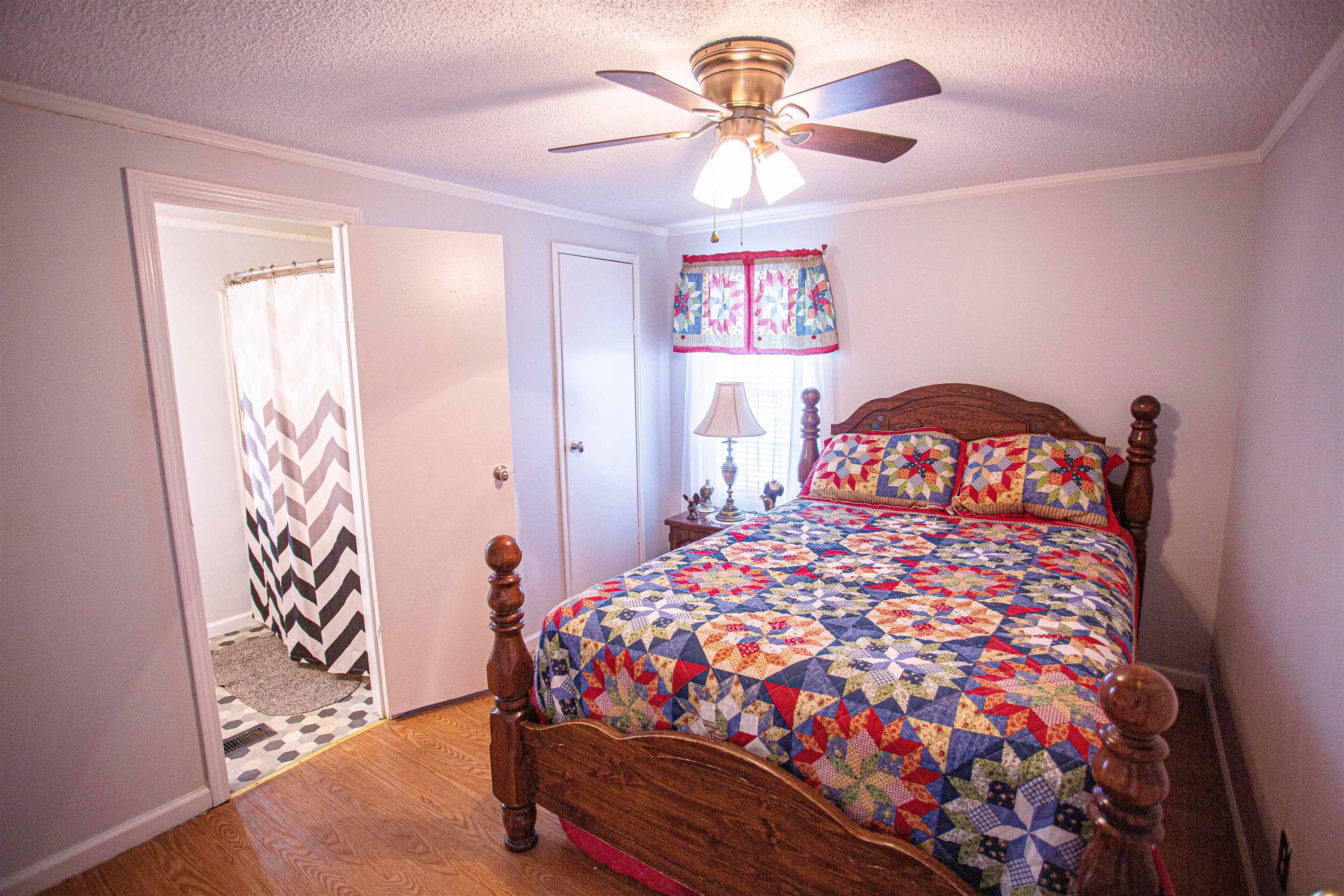 4100 Highway 209 Ripley, TN 38063 - Photo 18 of 36 a bedroom with a bed and a chandelier