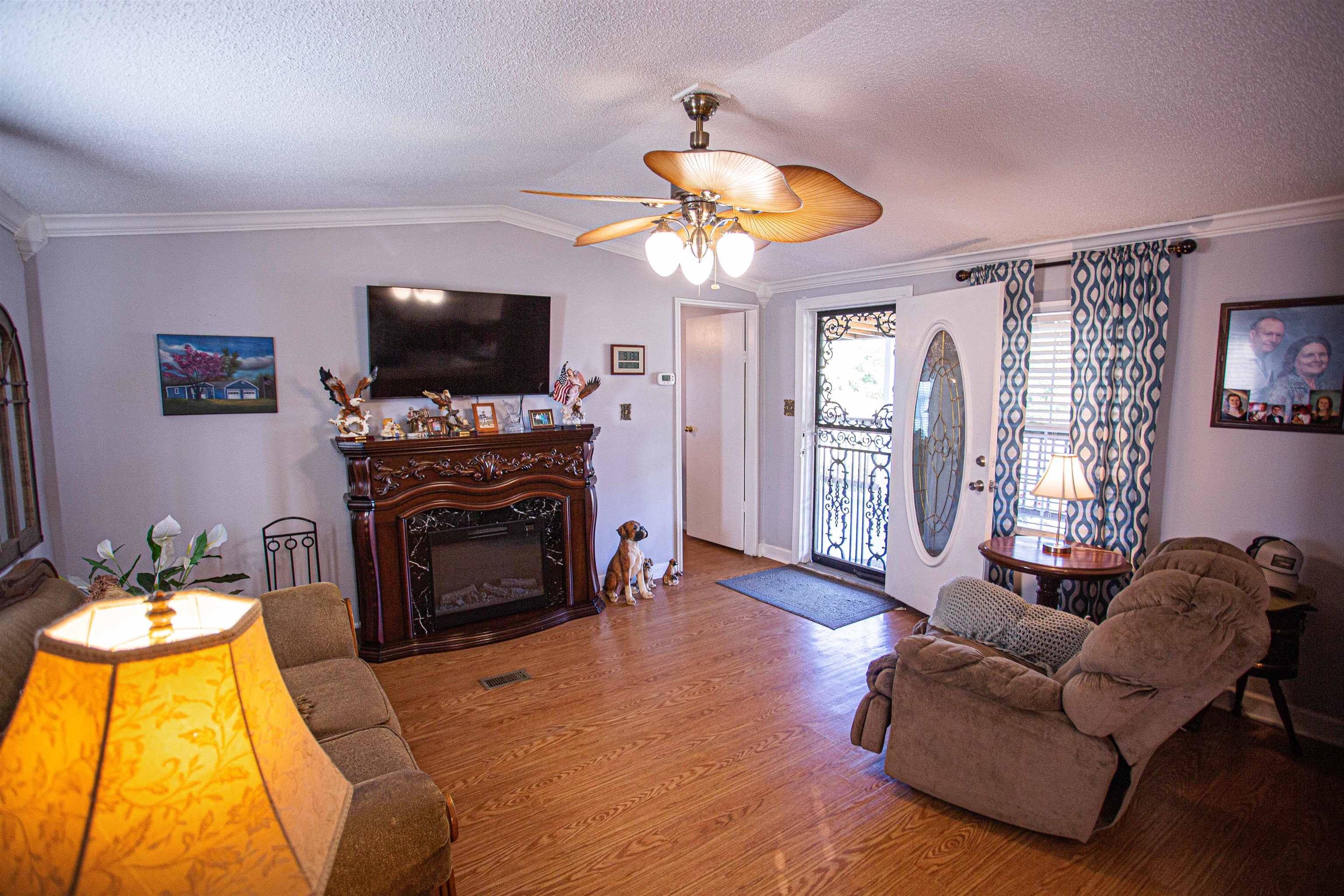 4100 Highway 209 Ripley, TN 38063 - Photo 4 of 36 a living room with furniture a flat screen tv and a fireplace
