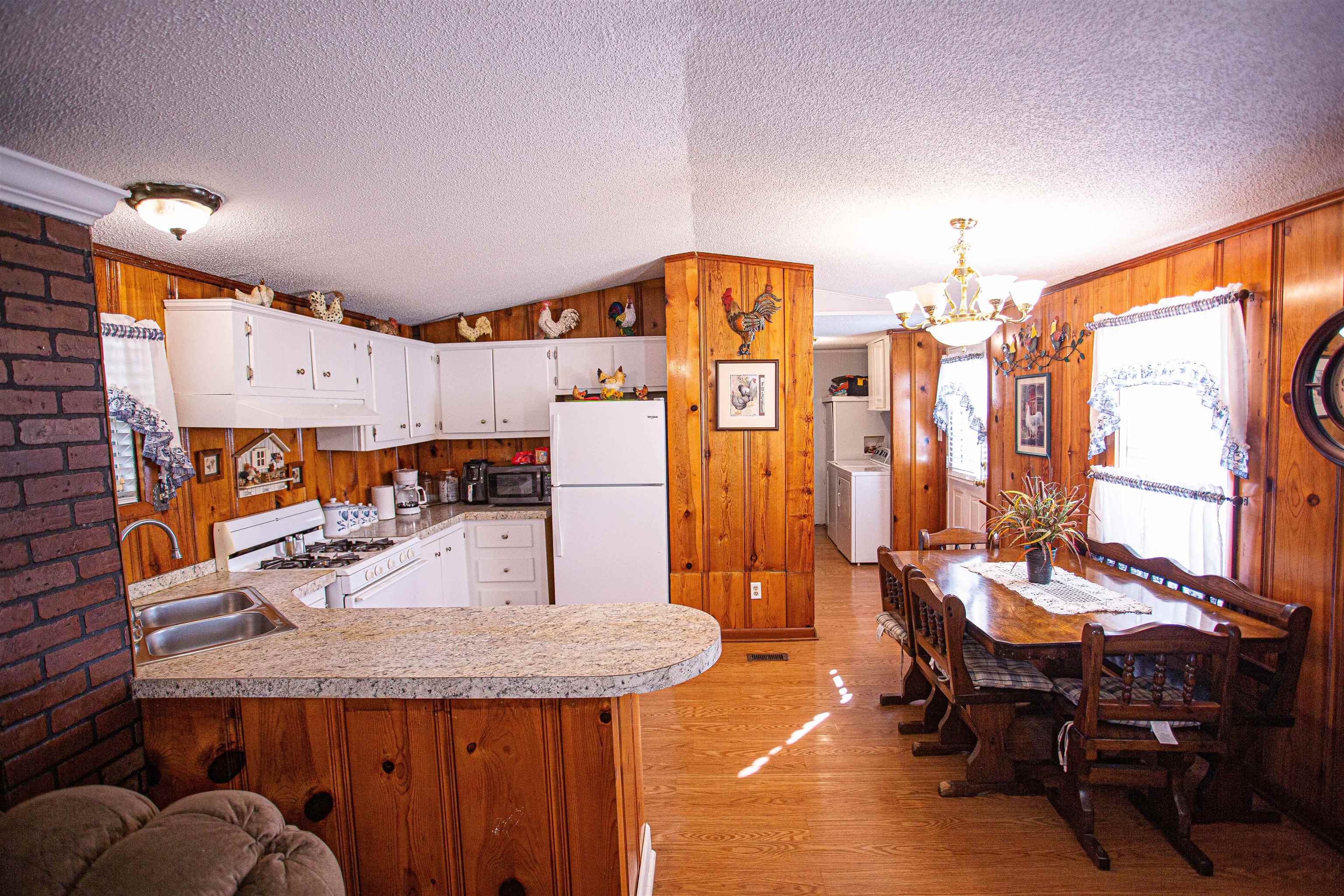 4100 Highway 209 Ripley, TN 38063 - Photo 8 of 36 a kitchen with stainless steel appliances kitchen island granite countertop a table chairs in it and a large window