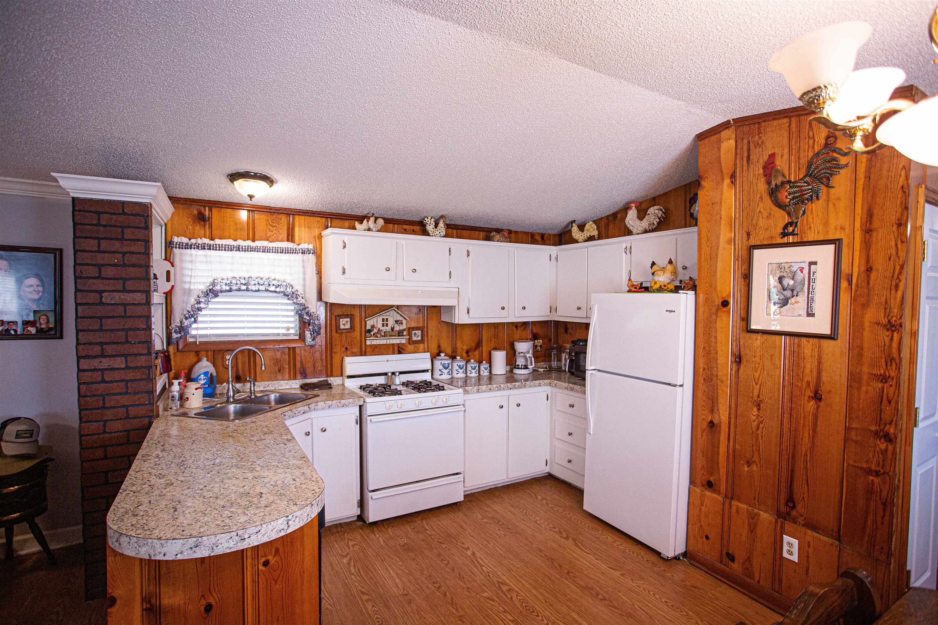 4100 Highway 209 Ripley, TN 38063 - Photo 10 of 36 a kitchen with furniture a refrigerator and wooden cabinets