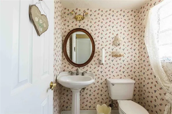 a bathroom with a sink toilet and a mirror